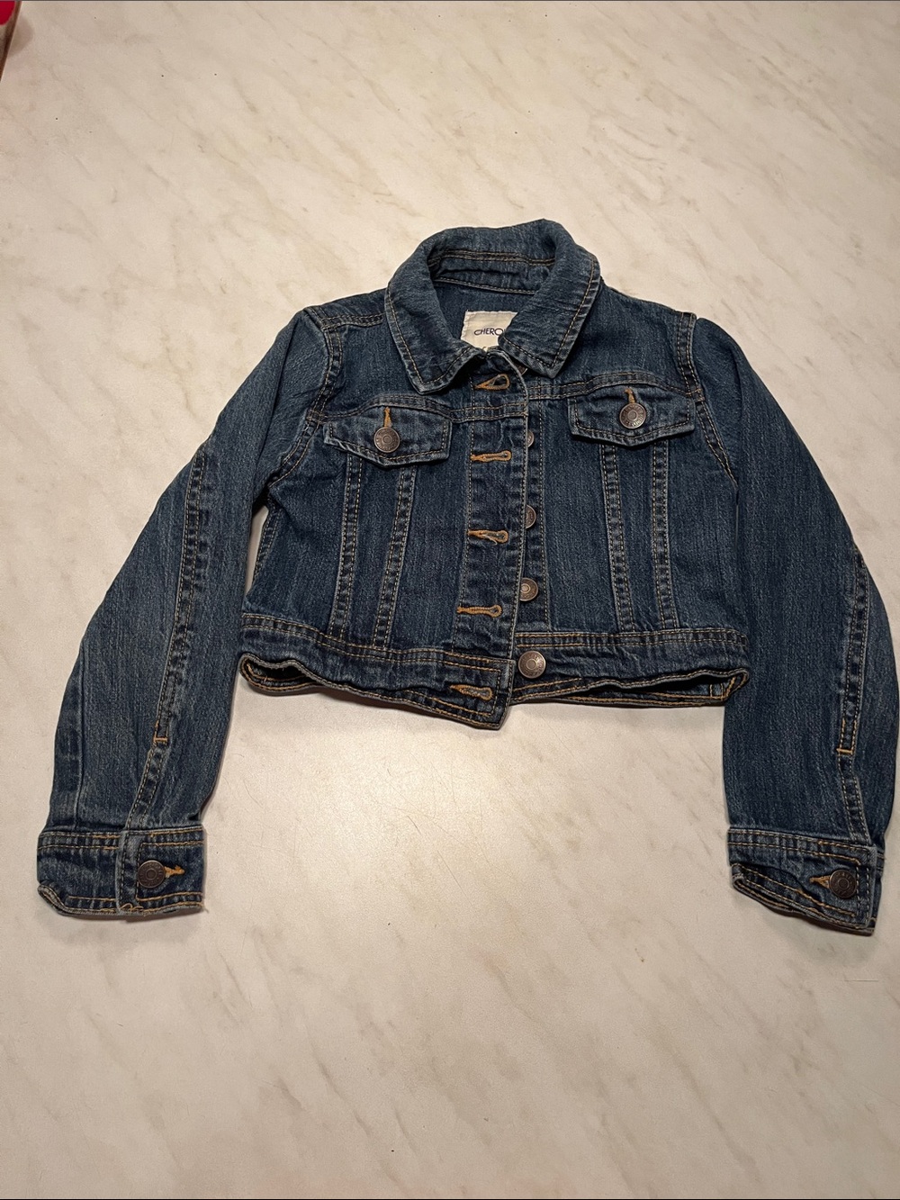 Cherokee beige label on dark denim